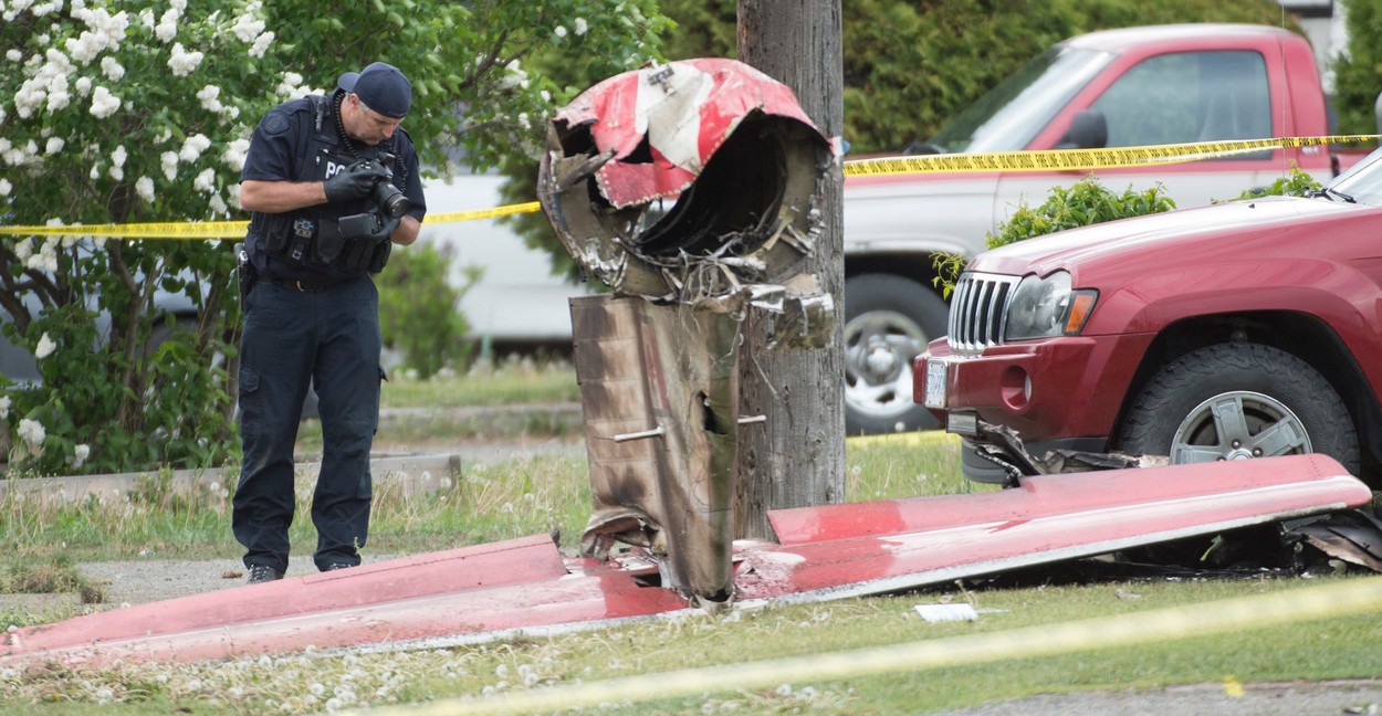 An RCMP photographer photographs the remains of a downed Canadian Forces Snowbird plane in Kamloops, BC, Canada, Sunday, May 17, 2020. One person has died and another is badly injured after a Canadian Forces Snowbird plane crashed in a residential area of Kamloops, B.C., while on a cross-country tour meant to impart hope during the COVID-19 pandemic., Image: 520227317, License: Rights-managed, Restrictions: , Model Release: no, Credit line: Hayward Jonathan/CP/ABACA / Abaca Press / Profimedia