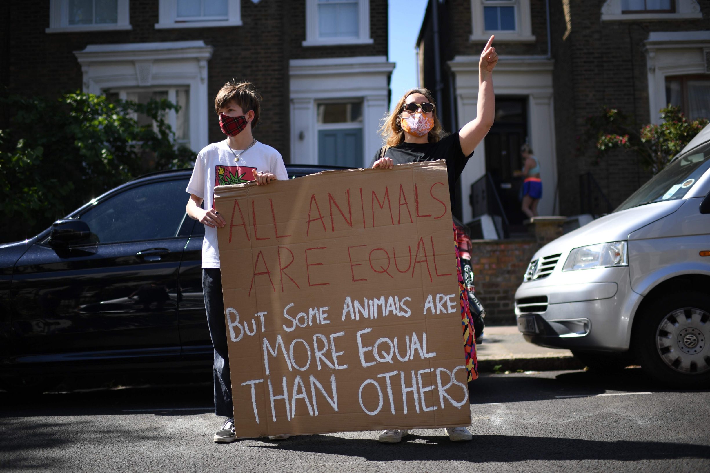 A pair of demonstrators display their homemade placard that reads 