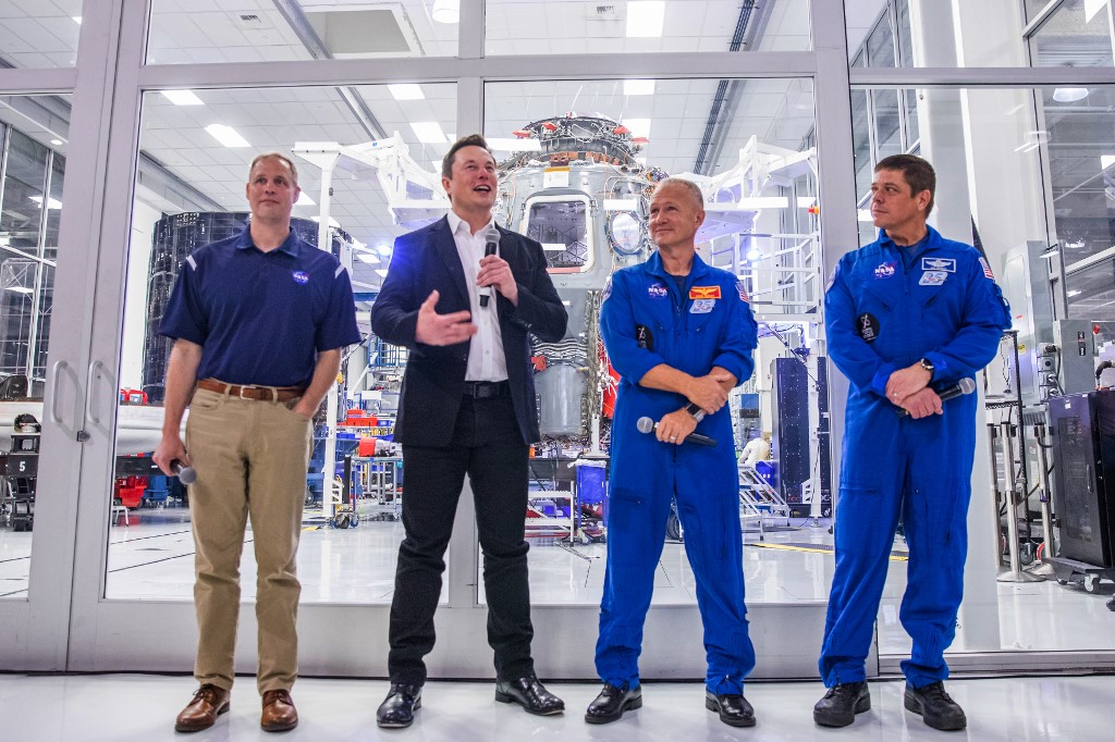 (FILES) In this file photo taken on October 10, 2019, SpaceX founder Elon Musk (2nd L) addresses the media alongside NASA Administrator Jim Bridenstine (L), and astronauts Douglas Hurley (2nd R) and Robert Behnken (R), during a press conference announcing new developments of the Crew Dragon reusable spacecraft, at SpaceX headquarters in Hawthorne, California. - SpaceX's aim, when it was incorporated on March 14, 2002, was to make low-cost rockets to travel one day to Mars -- and beyond. The 11th employee hired that year turned out to be someone good: Gwynne Shotwell, who was in charge of business development, soon established herself as Musk's right-hand woman. In the space industry, the two are given the rock star privilege of only being referred to by their first names. (Photo by Philip Pacheco / AFP)