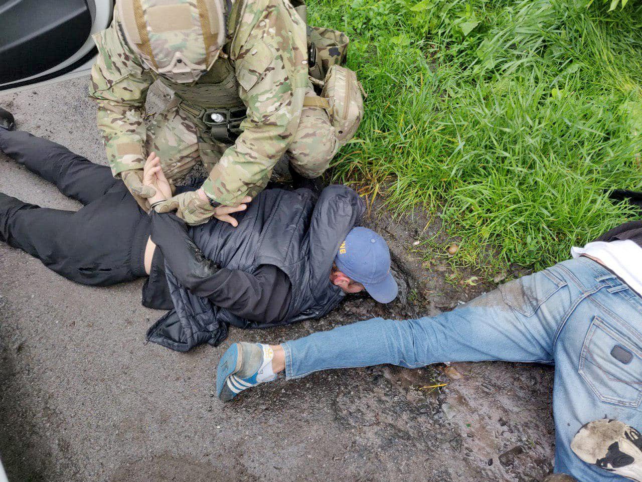 This handout picture taken and released by Ukrainian Interior Ministry press-service on May 29, 2020, shows people detained by the police in small town of Brovary, near Kiev. - Three people have been wounded and eleven arrested after a mass shootout between criminal gangs in a small town near Kiev, authorities said on May 29, 2020. Dozens of people staged a shootout early on May 29, in the streets of Brovary, a small town ten kilometres (eight miles) east of Kiev, police said. The cause of the clash was 