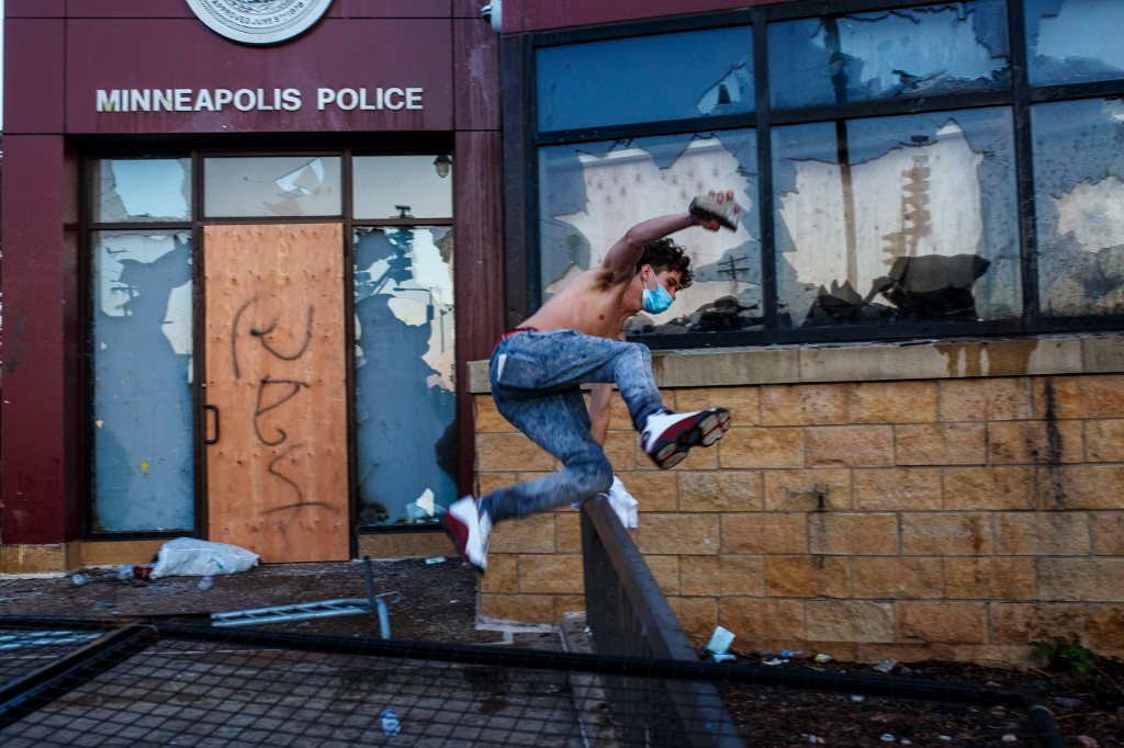 Protesters try to break into the Third Police Precinct on May 28, 2020 in Minneapolis, Minnesota, during a protest over the death of George Floyd, an unarmed black man, who died after a police officer kneeled on his neck for several minutes. - Authorities in Minneapolis and its sister city St. Paul got reinforcements from the National Guard on May 28 as they girded for fresh protests and violence over the shocking police killing of a handcuffed black man. Three days after a policeman was filmed holding his knee to George Floyd's neck for more than five minutes until he went limp, outrage continued to spread over the latest example of police mistreatment of African Americans. (Photo by Kerem Yucel / AFP)
