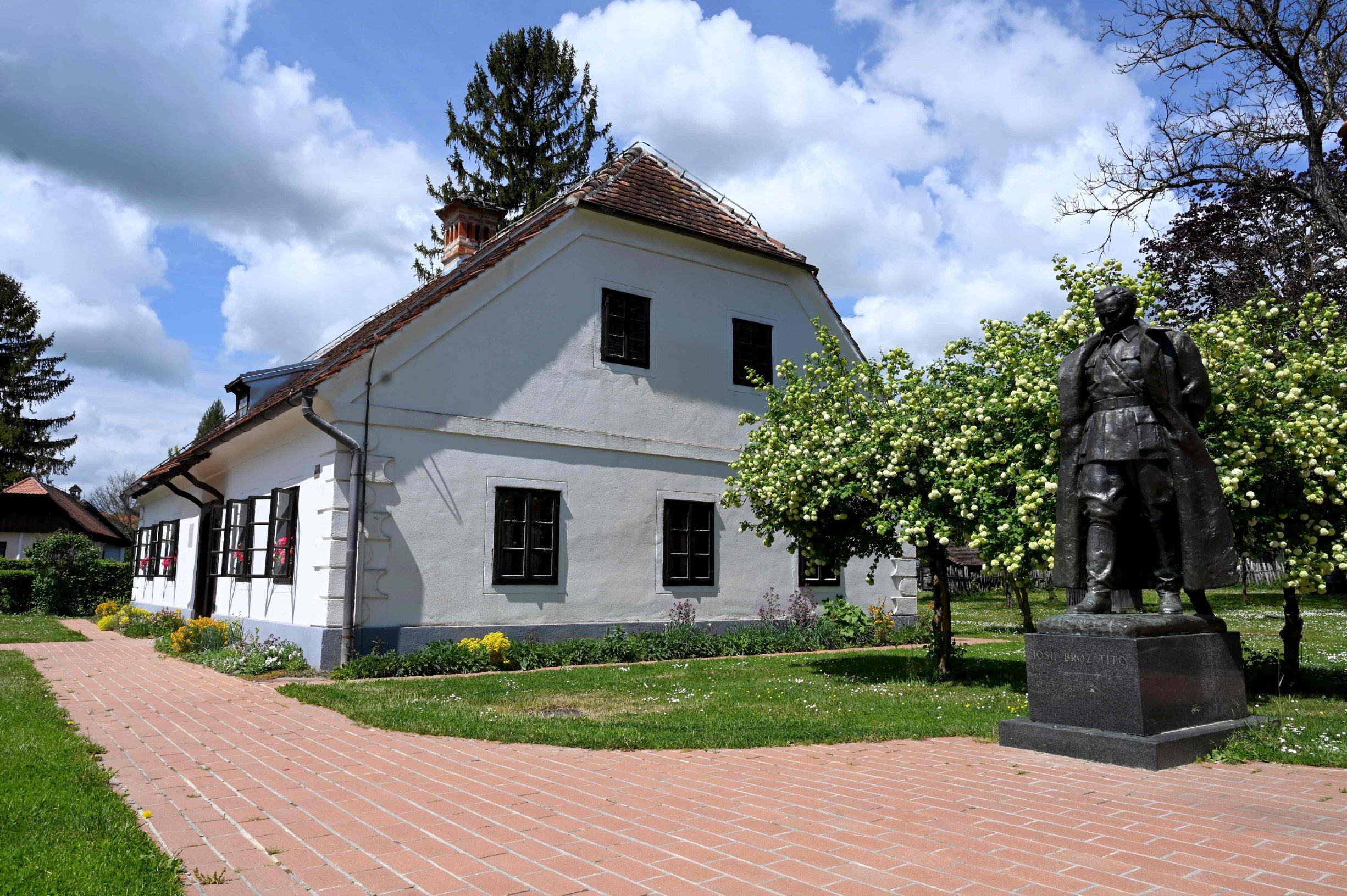 A picture taken on April 30, 2020 shows the statue by Croatian sculptor Antun Augustincic (19001979), of Josip Broz Tito (18921980), former President of communist Yugoslavia, next to the museum in Josip Broz Tito's birth house in the village of Kumrovec, some 50 km from Zagreb. - A benevolent unifier or a power-hungry dictator? On the 40th anniversary of his death, the late Yugoslav leader Josip Broz Tito's legacy is still a topic of debate. (Photo by Denis LOVROVIC / AFP)