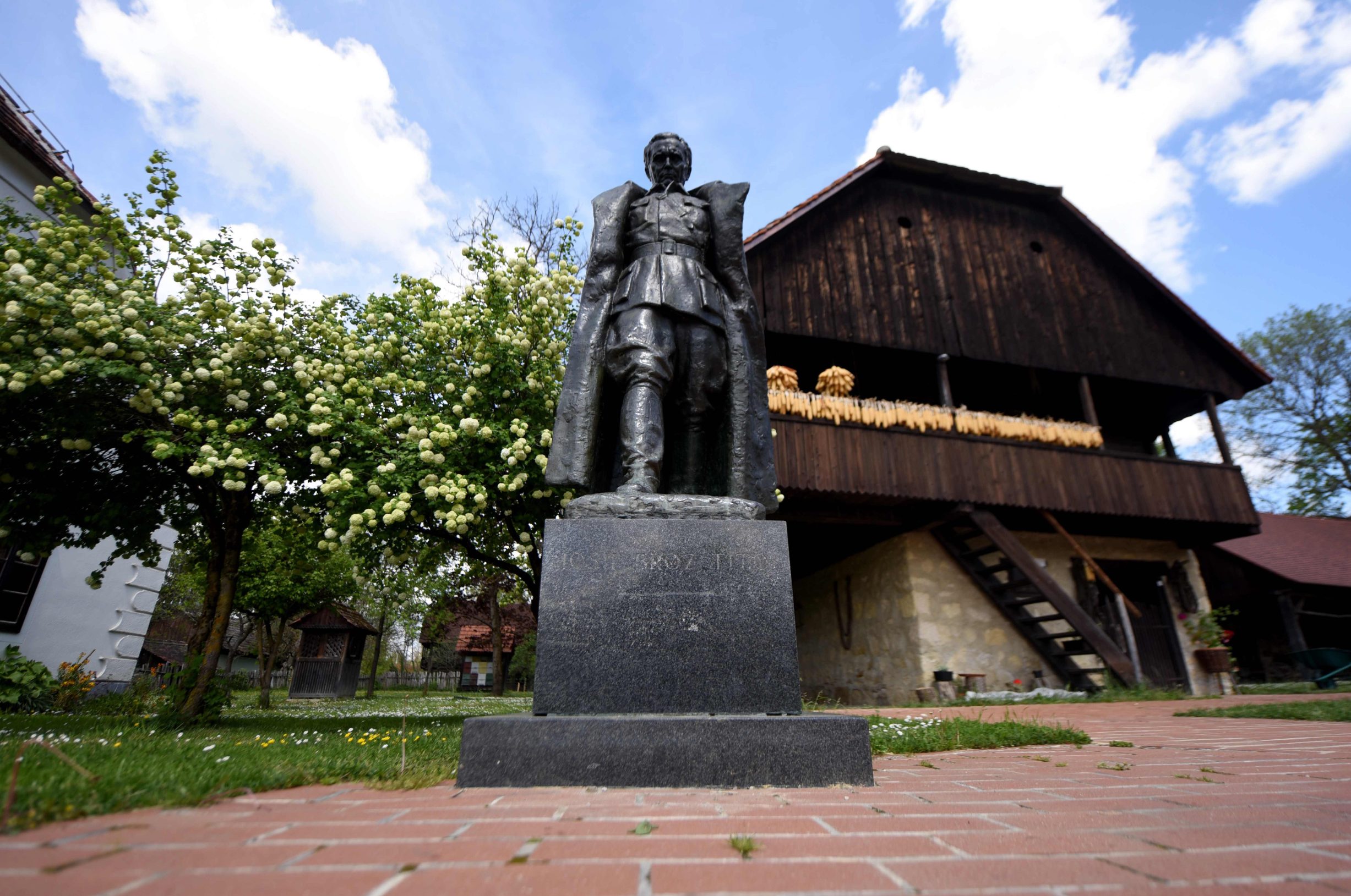 A picture taken on April 30, 2020 shows the statue by Croatian sculptor Antun Augustincic (19001979), of Josip Broz Tito (18921980), former President of communist Yugoslavia, next to the museum in Josip Broz Tito's birth house in the village of Kumrovec, some 50 km from Zagreb. - A benevolent unifier or a power-hungry dictator? On the 40th anniversary of his death, the late Yugoslav leader Josip Broz Tito's legacy is still a topic of debate. (Photo by Denis LOVROVIC / AFP)