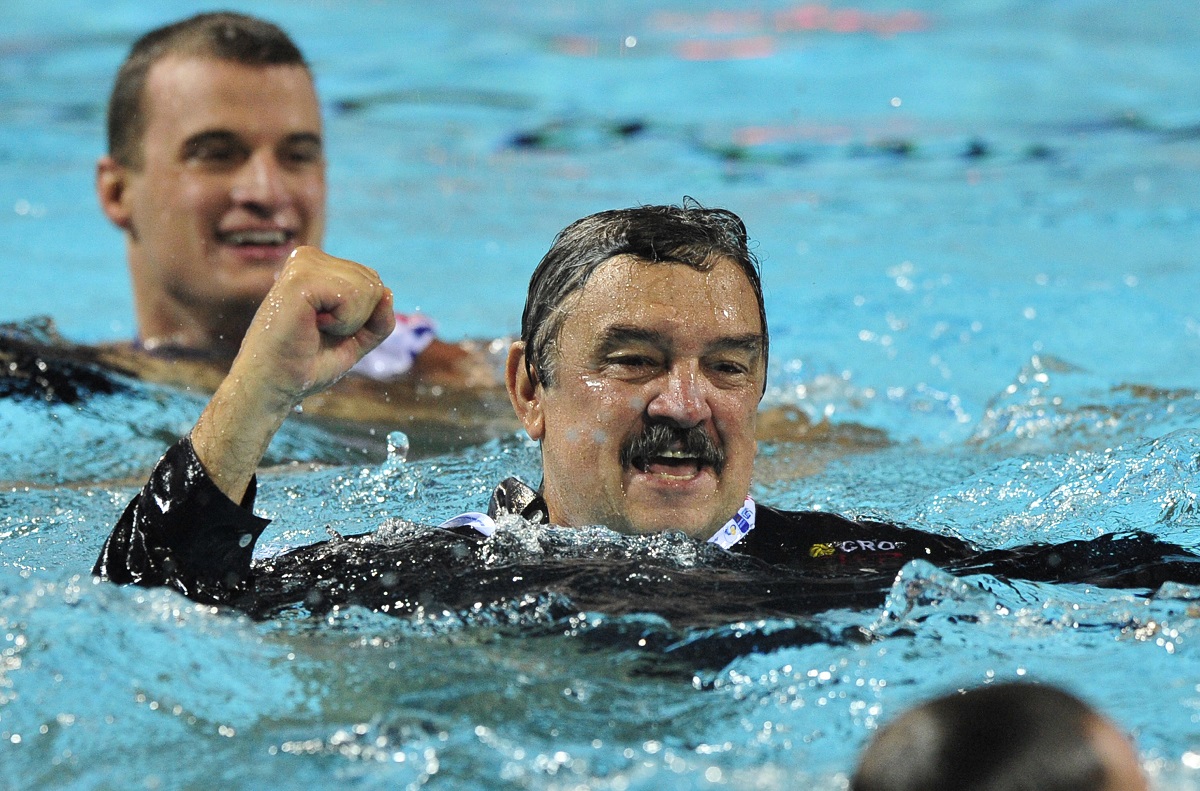 Croatia's coach Ratko Rudic (C) celebrates after he was thrown into the pool by his players after the European Waterpolo Championships mens final match against Italy in Zagreb, on September 11, 2010. Croatia won 7-3 to win the championship.  AFP PHOTO / ATTILA KISBENEDEK (Photo by ATTILA KISBENEDEK / AFP)