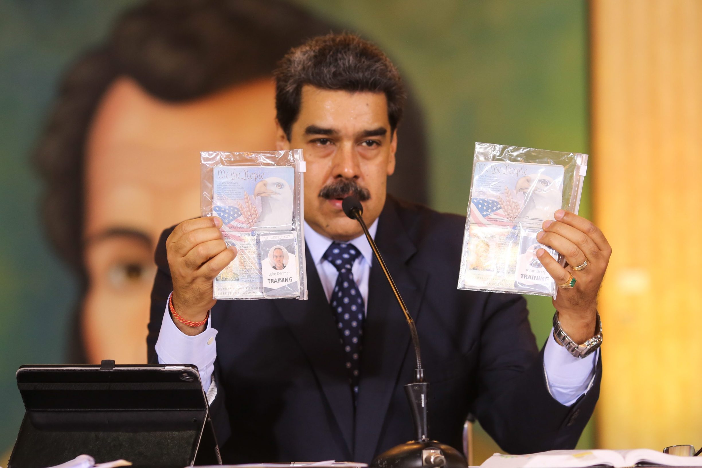 Handout picture released by the Venezuelan Presidency of Venezuelan President Nicolas Maduro showing the passports of two US citizens arrested by security forces during a video conference meeting with international media correspondents, at Miraflores Presidential Palace in Caracas, on May 6, 2020. - Venezuela is to try two Americans allegedly captured during a failed sea attack by mercenaries, President Nicolas Maduro said on Wednesday. (Photo by Marcelo Garcia / Venezuelan Presidency / AFP) / RESTRICTED TO EDITORIAL USE - MANDATORY CREDIT 