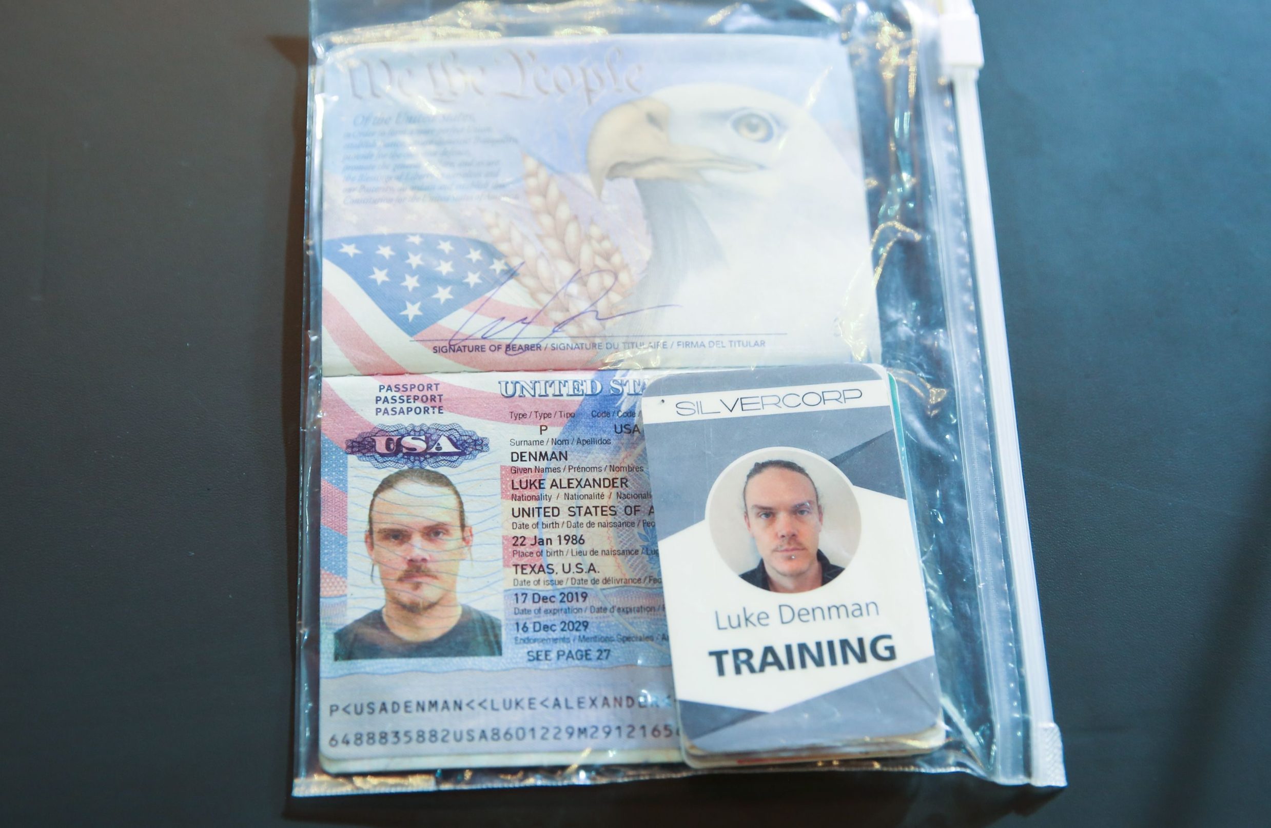 Handout picture released by the Venezuelan Presidency showing the passport of arrrested US citizen Luke Deman, during a video conference meeting with international media correspondents, at Miraflores Presidential Palace in Caracas, on May 6, 2020. - Venezuela is to try two Americans, identified as Luke Denman and Airan Berry, allegedly captured during a failed sea attack by mercenaries, President Nicolas Maduro said on May 6. (Photo by Marcelo Garcia / Venezuelan Presidency / AFP) / RESTRICTED TO EDITORIAL USE - MANDATORY CREDIT 