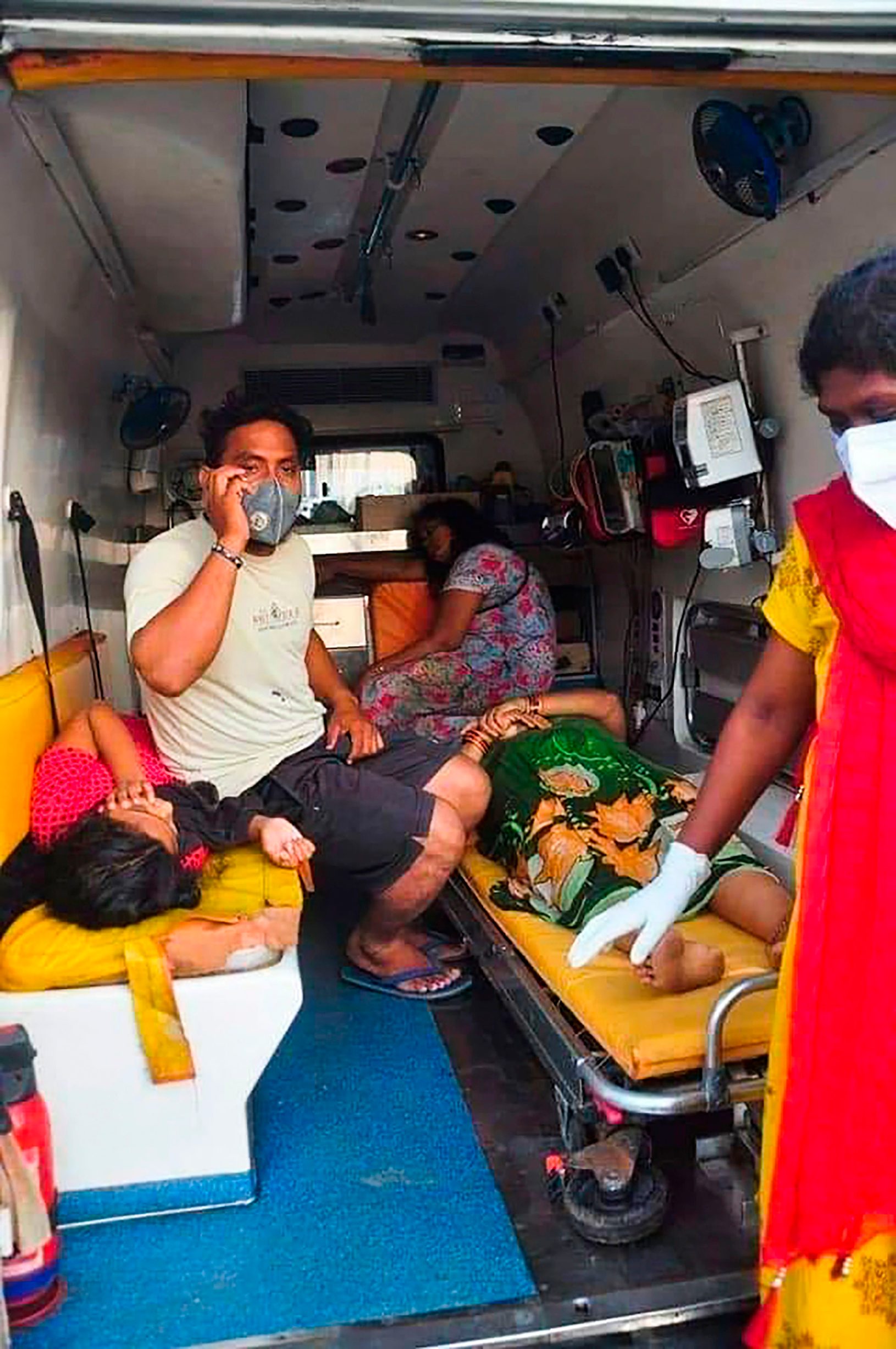 Women are evacuated to a hospital  in an ambulance following a gas leak incident from an LG Polymers plant in Visakhapatnam on May 7, 2020. - At least five people have been killed and several hundred hospitalised after a gas leak at a chemicals plant on the east coast of India, police said on May 7. They said that the gas had leaked out of two 5,000-tonne tanks that had been unattended due to India's coronavirus lockdown in place since late March. (Photo by - / AFP)