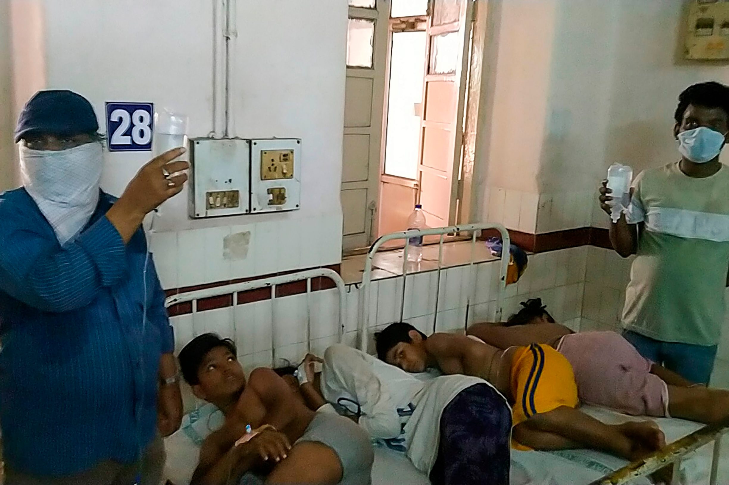 EDITORS NOTE: Graphic content / Children affected by a gas leak from an LG Polymers plant lay on beds at the King George hospital in Visakhapatnam on May 7, 2020. - At least five people have been killed and 1,000 hospitalised after a gas leak at a chemicals plant on the east coast of India, authorities said on May 7, warning the death toll would climb. The gas leaked out of two 5,000-tonne tanks that had been unattended due to India's coronavirus lockdown in place since late March, according to a local police officer. (Photo by - / AFP)