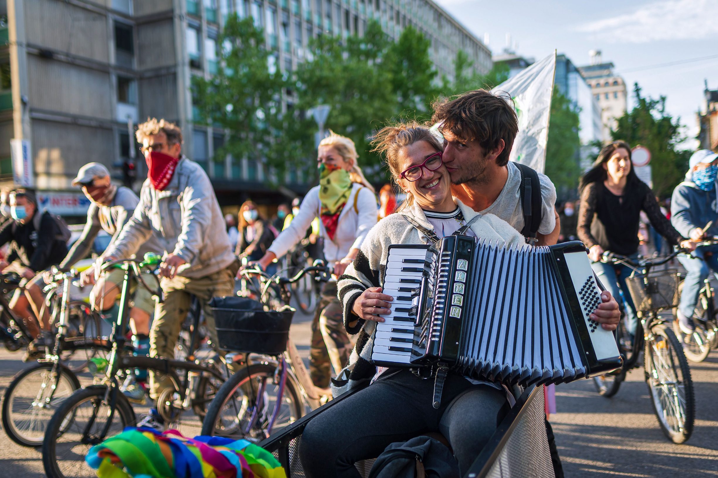 A Slovenian citizen plays accordion as she and others ride their bikes as they block the centre of capital Ljubljana to protest against the centre-right government, accusing it of corruption and of using the novel coronavirus crisis to restrict freedom on May 8, 2020 amid the COVID-19 outbreak, caused by the novel coronavirus. (Photo by Jure Makovec / AFP)