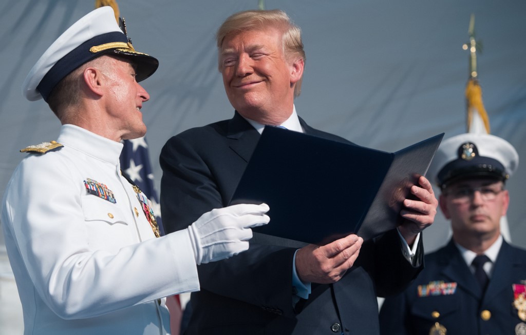US President Donald Trump speaks with Admiral Paul Zukunft (L) as he retires as Commandant of the US Coast Guard during a Change of Command ceremony as Admiral Karl Schultz takes over as Commandant at US Coast Guard Headquarters in Washington, DC, June 1, 2018. (Photo by SAUL LOEB / AFP)