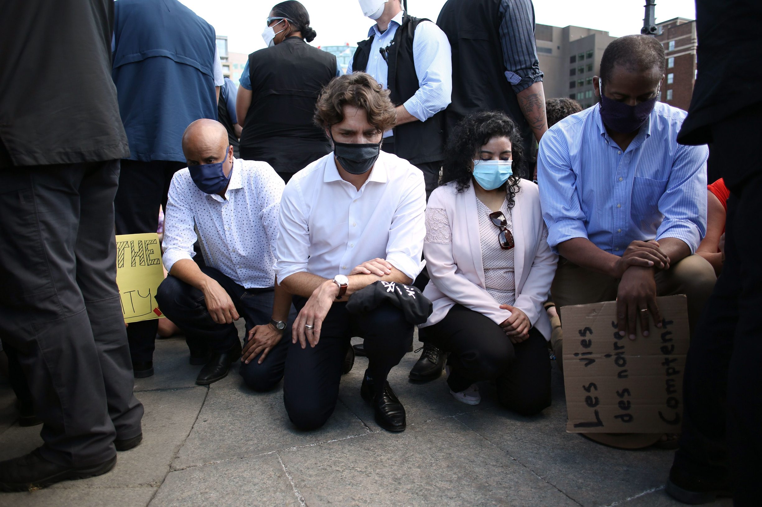 Canadadian Prime Minister Justin Trudeau (2nd L) takes a knee during in a Black Lives Matter protest on Parliament Hill June 5, 2020 in Ottawa, Canada. - Canadian Prime Minister Justin Trudeau appeared at a loss for words on June 2, pausing for 20 seconds when pressed for this thoughts on US President Donald Trump's threat of military mobilization against violent US protests. (Photo by Dave Chan / AFP)