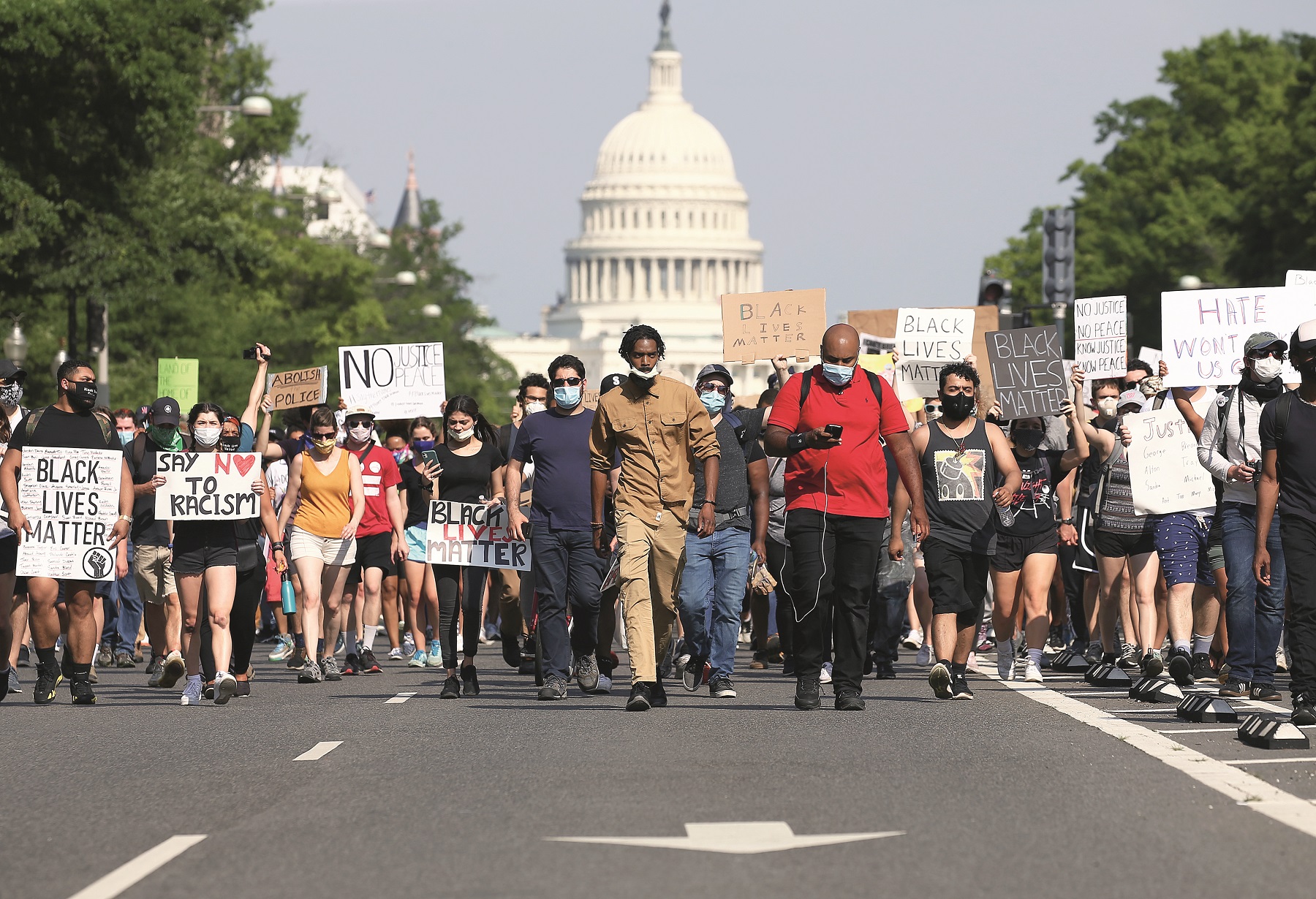 WASHINGTON, DC - JUNE 03: Demonstrators march down Pennsylvania Avenue near the Trump International Hotel during a protest against police brutality and the death of George Floyd, on June 3, 2020 in Washington, DC. Protests in cities throughout the country have been been held after the death of George Floyd, a black man who was killed in police custody in Minneapolis on May 25.  (Photo by Tasos Katopodis/Getty Images)