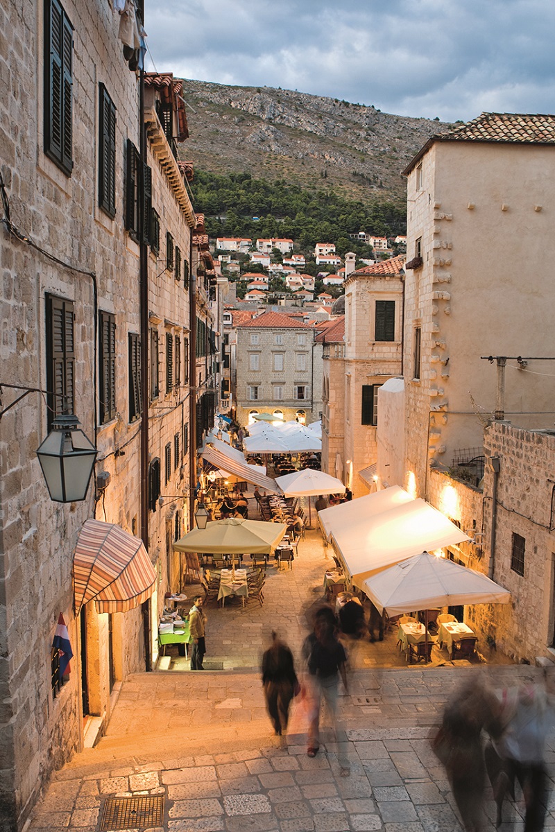 Colorful cafes and vendors in the market at Gunduliceva Poljana.  In the Stari Grad (Old Town) of Dubrovnik.  A UNESCO World Heritage Site.  Dusk light.