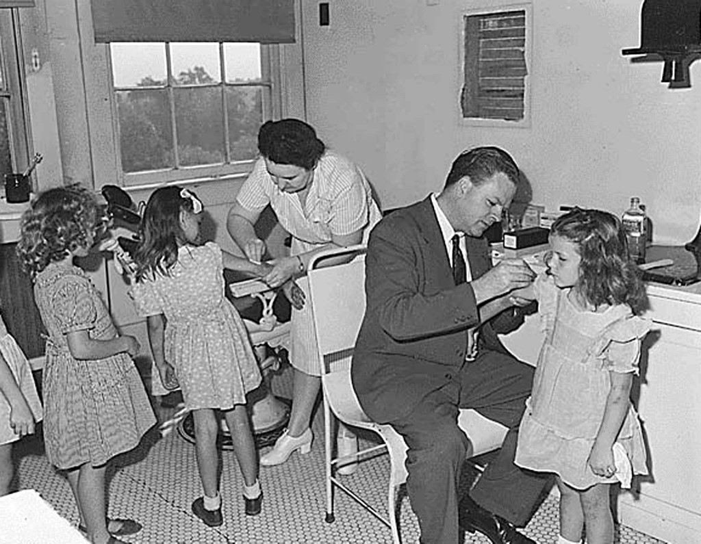 (FILES) This file photo taken 01 August 1946 in Jewell Ridge,Tazewell County,Virginia, shows Jewell Ridge Coal Company Dr. Tiernan, as he gives  an examination and smallpox vaccination to pre-school children. US military personnel and emergency workers will begin receiving smallpox vaccines in 2003 as part of a plan to thwart any terrorist attack using the deadly virus, a US official said 11 December, 2002. Under the blueprint, which US President George W. Bush is set to unveil 13 December, the entire US population will have the opportunity to choose to be vaccinated by some time in 2004, said the official, who declined to be named. AFP PHOTO/NATIONAL ARCHIVES (Photo by HO / THE NATIONAL ARCHIVES / AFP)