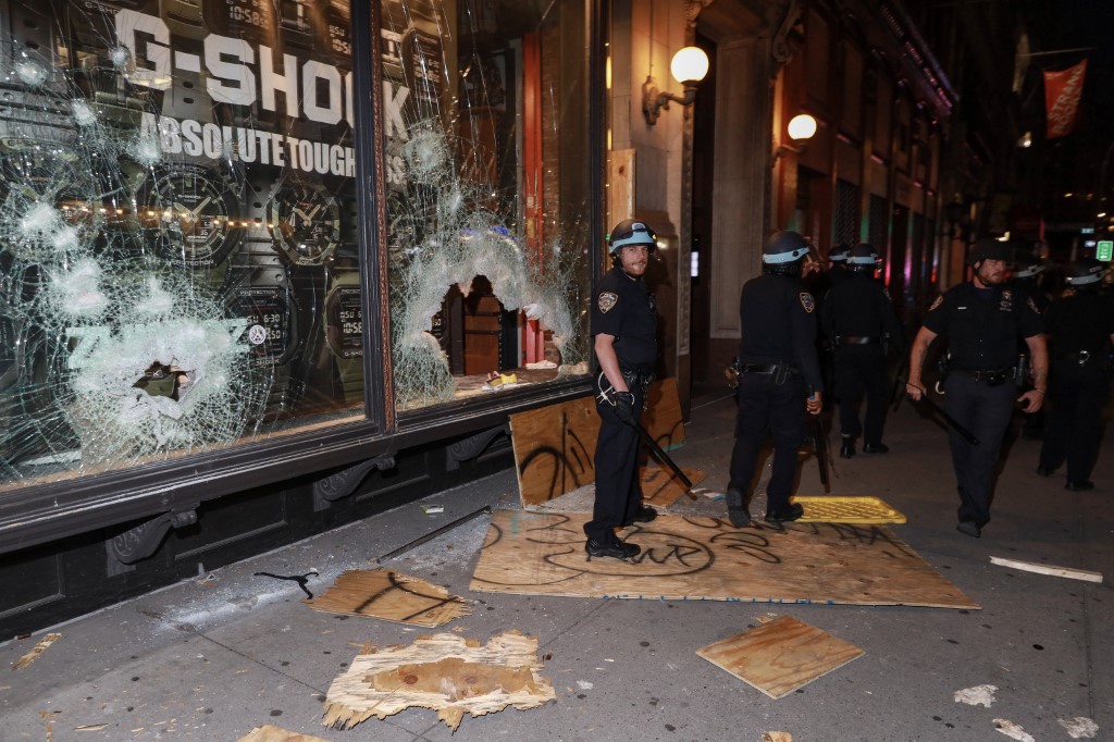 NEW YORK, USA - JUNE 01: Police officers inspect the store after looting during a protest over the death of George Floyd, an unarmed black man who died after being pinned down by a white police officer in Minneapolis, in Manhattan, New York City, United States on June 01, 2020. Mostafa Bassim / Anadolu Agency
