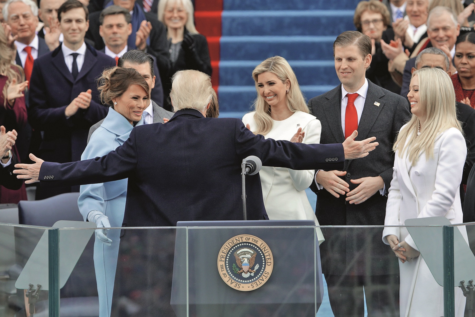 WASHINGTON, DC - JANUARY 20:  President Donald Trump reaches out to embrace son Barron Trump as  First Lady Melania Trump,  Ivanka Trump (C), Eric Trump and Tiffany Trump look on after his inauguration on the West Front of the U.S. Capitol on January 20, 2017 in Washington, DC. In today's inauguration ceremony Donald J. Trump becomes the 45th president of the United States.  (Photo by Alex Wong/Getty Images)