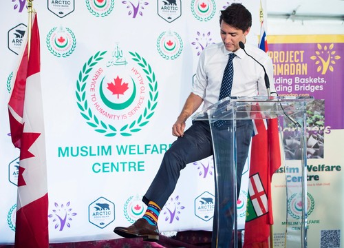 Prime Minister Justin Trudeau shows of his Ramadan color socks after helping prepare food baskets for Project Ramadan at the Muslim Welfare Centre in Scarborough, Ont., on Thursday, June 22, 2017.,Image: 338814586, License: Rights-managed, Restrictions: World rights excluding North America, Model Release: no