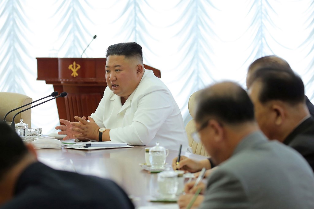 In this picture taken on June 7, 2020 and released from North Korea's official Korean Central News Agency (KCNA) on June 8, 2020 North Korean leader Kim Jong Un (C) speaks during the 13th Political Bureau meeting of the 7th Central Committee of the Workers' Party of Korea (WPK) in an undisclosed location in North Korea. (Photo by STR / KCNA VIA KNS / AFP) / South Korea OUT / ---EDITORS NOTE--- RESTRICTED TO EDITORIAL USE - MANDATORY CREDIT 