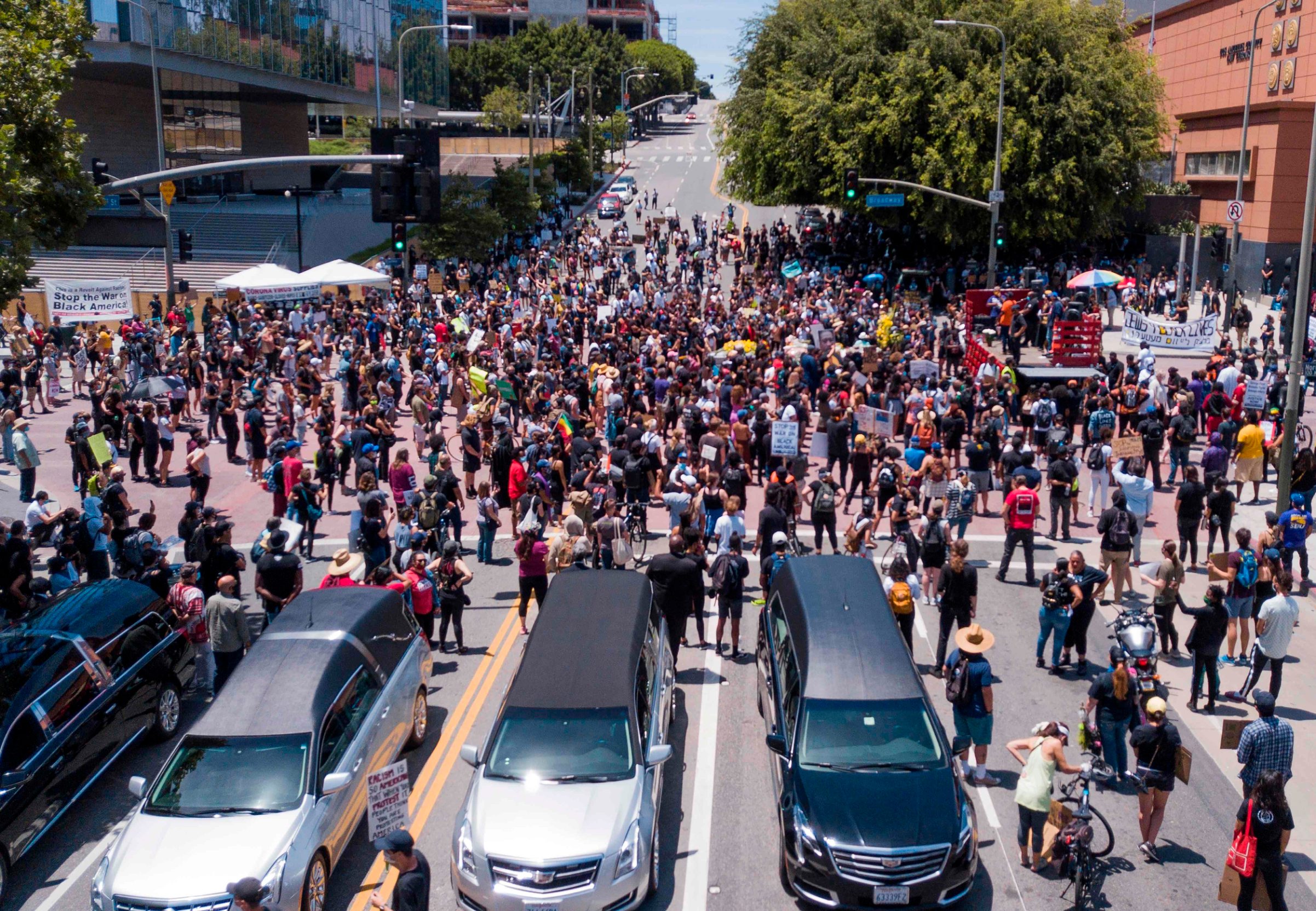 TOPSHOT - Black Lives Matter (BLM) supporters gather for a memorial service honoring George Floyd in downtown Los Angeles, California, on June 8, 2020. - Hearses from four different parts of greater Los Angeles meet downtown for the peaceful interfaith gathering as demonstrations continued across the nation to demand police reform and social justice. (Photo by Robyn Beck / AFP)