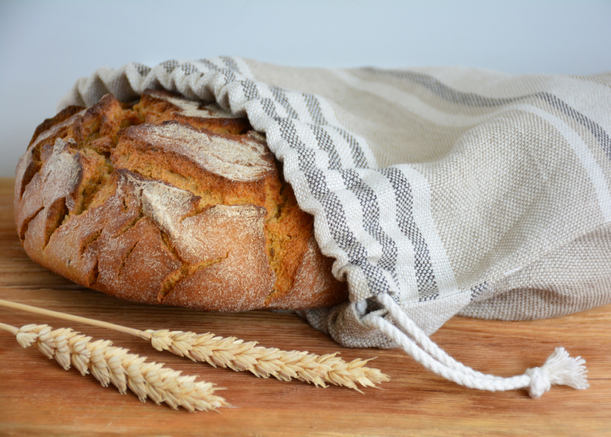 Bread loaf in reusable zero waste linen bread bag, close-up view