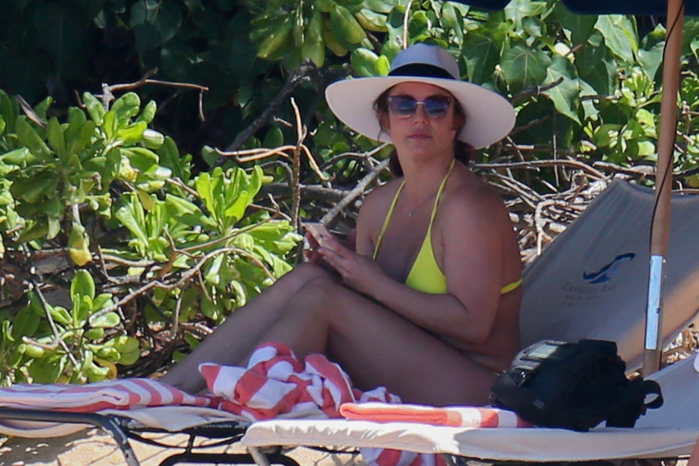 Honolulu, HI  - *PREMIUM-EXCLUSIVE* **WEB EMBARGO UNTIL 2 pm EST on September 12, 2019**  Britney Spears rocks a itty bitty yellow bikini at the beach in Hawaii. The singer looks to be enjoying some downtime after recently getting a new conservator after her father stepped down due to 'health reasons. The singer has maintained a very low profile recently as her father stepped down as her conservator after Britney’s ex Kevin Federline accused him of abuse against their son. *Shot on 09/10/19*

BACKGRID USA 12 SEPTEMBER 2019,Image: 470456779, License: Rights-managed, Restrictions: Code Cory Labore 20%, Model Release: no, Credit line: BACKGRID / Backgrid USA / Profimedia