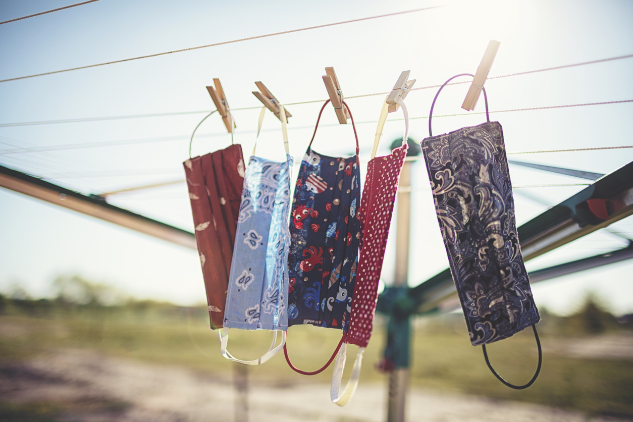 Self-sewn mouth-nose masks against corona viruses hang on the clothesline to dry.