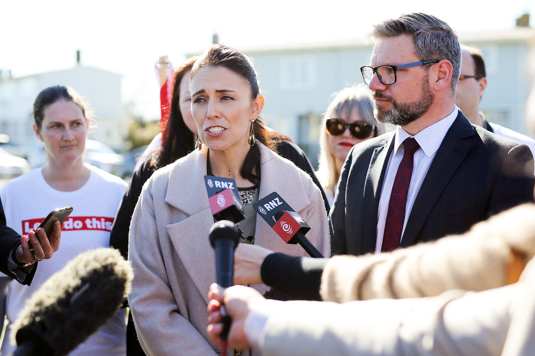 PALMERSTON NORTH, NEW ZEALAND - AUGUST 23:  Labour leader Jacinda Ardern speaks to media while MP for Palmerston North, Iain Lees-Galloway, looks on during a housing announcement at Farnham Park on August 23, 2017 in Palmerston North, New Zealand. Ardern announced that Labour will build 149 homes in Palmerston North, a mix of KiwiBuild starter homes for first homebuyers and state houses, to help tackle home affordability and homelessness.  (Photo by Hagen Hopkins/Getty Images)