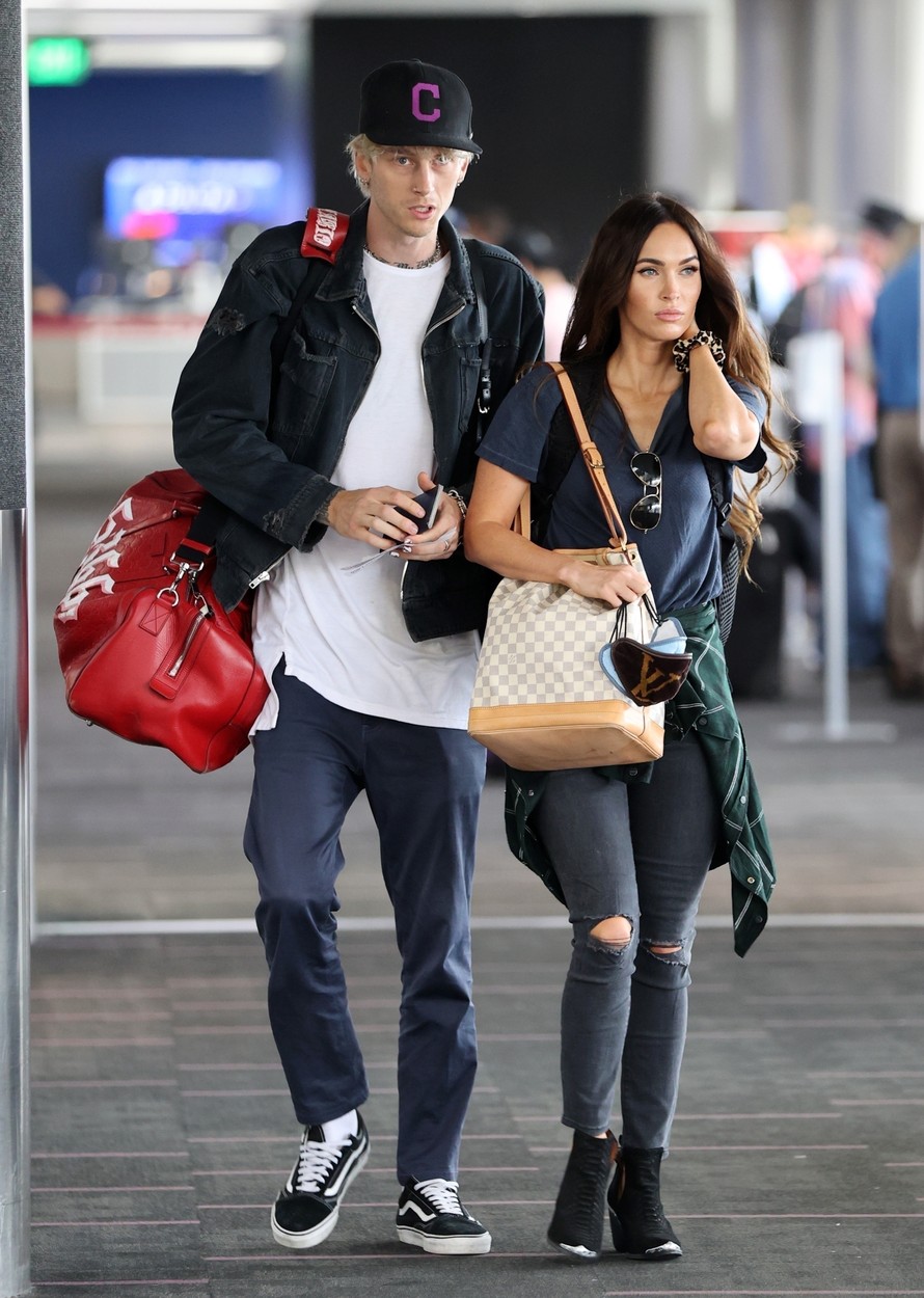 Los Angeles, CA  - *PREMIUM-EXCLUSIVE*  - *Web Embargo until 12:40 Pm EDT on June 30, 2020*  Megan Fox and Machine Gun Kelly are seen arriving at LAX airport together for what appears to be their first getaway together since first being spotted together as a couple. The loved up pair were seen  arriving at LAX on Saturday carrying a few bags that seemed to hint at a weekend getaway. MGK carried two large  bags including a red Gucci duffel while Megan, dressed in ripped jeans, t-shirt, booties and a flannel shirt tied around her waist carried a Gucci bucket bag.The couple cuddled closely while waiting online to go through security. *Shot on June 27, 2020*

*UK Clients - Pictures Containing Children
Please Pixelate Face Prior To Publication*,Image: 537187794, License: Rights-managed, Restrictions: , Model Release: no, Credit line: Clint Brewer Photography / Jack / BACKGRID / Backgrid USA / Profimedia