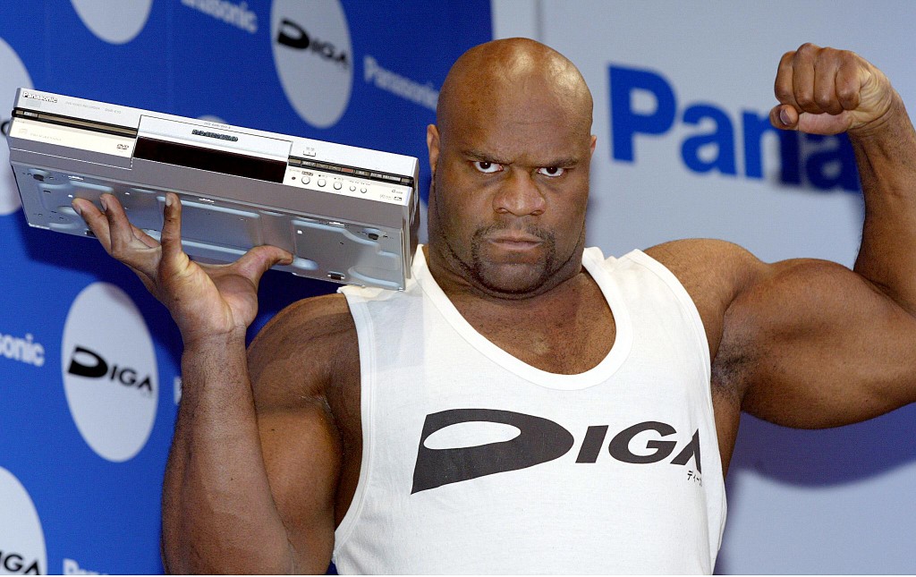 US wrestler Bob Sapp poses for photographers with Panasonic's latest DVD video recorder during a press preview in Tokyo, 05 February 2003.  Sapp is selected as an image charactor for Panasonic's DVD video recorder.   AFP PHOTO / TOSHIFUMI KITAMURA (Photo by TOSHIFUMI KITAMURA / AFP)