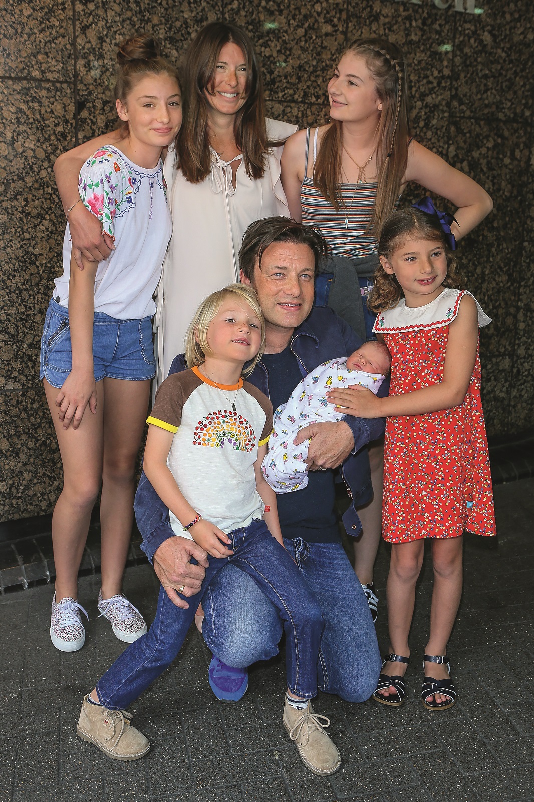 Jamie Oliver, Jools Oliver and their family  pose with their new baby at The Portland Street Hospital on August 8, 2016 in London, England.