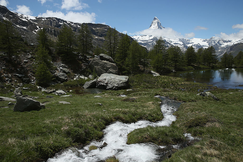 ZERMATT, SWITZERLAND - JUNE 30:  A small stream leads to a lake near Sunnegga station as the Matterhorn stands behind on June 30, 2013 near Zermatt, Switzerland. Zermatt is among Switzerland's most famous winter and summer tourism destinations.  (Photo by Sean Gallup/Getty Images)