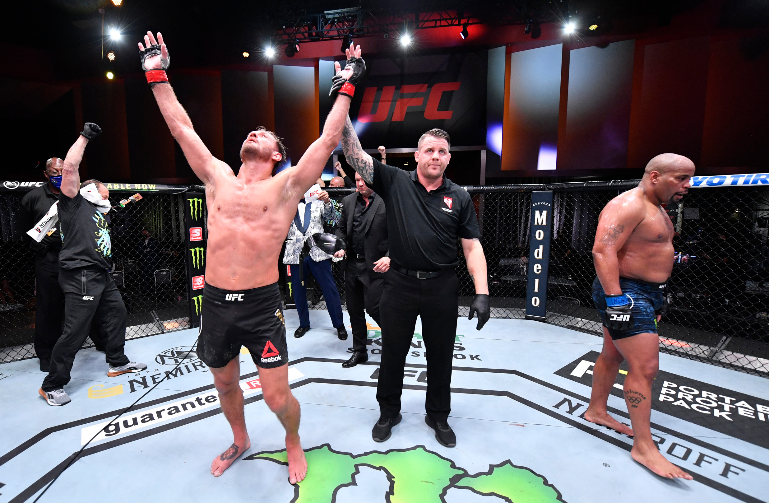 LAS VEGAS, NEVADA - AUGUST 15: In this handout image provided by UFC, Stipe Miocic celebrates after his victory over Daniel Cormier in their UFC heavyweight championship bout during the UFC 252 event at UFC APEX on August 15, 2020 in Las Vegas, Nevada. (Photo by Jeff Bottari/Zuffa LLC via Getty Images)