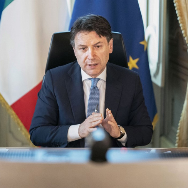 This photo taken and handout on April 23, 2020 by the Palazzo Chigi Press Office in Rome shows Italy's Prime Minister Giuseppe Conte taking part from his office at Palazzo Chigi in Rome to a videoconference of EU leaders on the virus economic impact, during the country's lockdown aimed at curbing the spread of the COVID-19 infection, caused by the novel coronavirus. - EU leaders are set to haggle on April 23 over a giant package to help their economies recover from the coronavirus pandemic, but bitter divisions mean little progress is expected. 