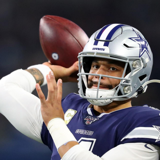 (FILES) In this file photo taken on November 10, 2019, Dak Prescott of the Dallas Cowboys warms up before the game against the Minnesota Vikings at AT&T Stadium in Arlington, Texas. - Prescott will play the 2020 NFL season on a one-year ”franchise” player contract worth $31.4 million after failing to get a long-term deal done with the team. Prescott had turned down a five-year deal worth more than $34 million annually that included $110 million in guaranteed money, the Fort Worth Star Telegram reported, saying the quarterback had wanted a four-year deal. (Photo by TOM PENNINGTON/GETTY IMAGES NORTH AMERICA/AFP)