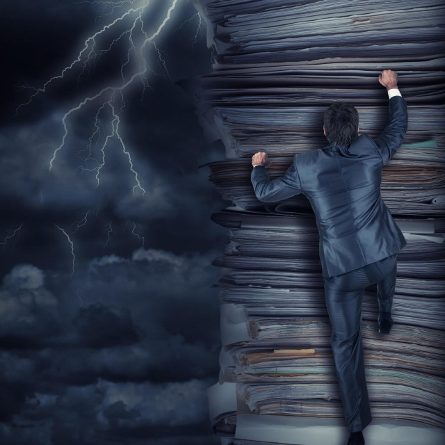 Businessmen climbing up a pile of documents at storm,Image: 542826534, License: Royalty-free, Restrictions:, Model Release: no, Credit line: Sergiy Tryapitsyn/Panthermedia/Profimedia