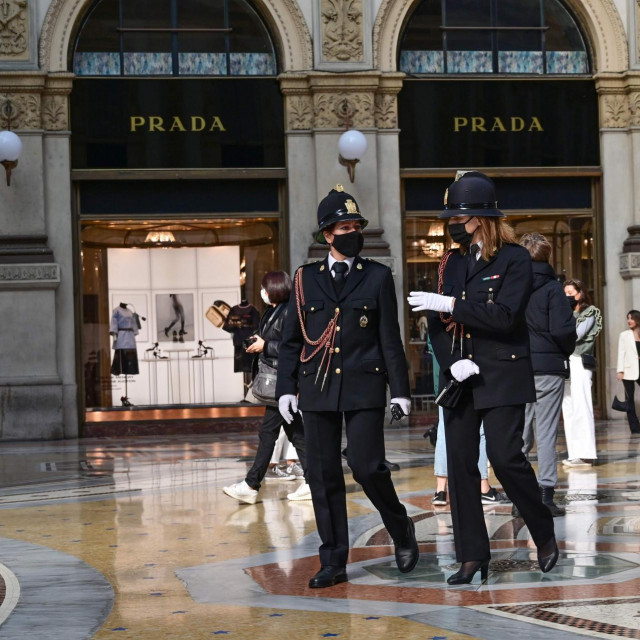 Police officers wearing protective masks walk across the Galleria Vittorio Emanuele II in Milan on October 17, 2020, amid the Covid-19 pandemic. - Italy's government has made it mandatory to wear face protection outdoors, in an attempt to counter the spread of the coronavirus Covid-19 pandemic. (Photo by MIGUEL MEDINA/AFP)