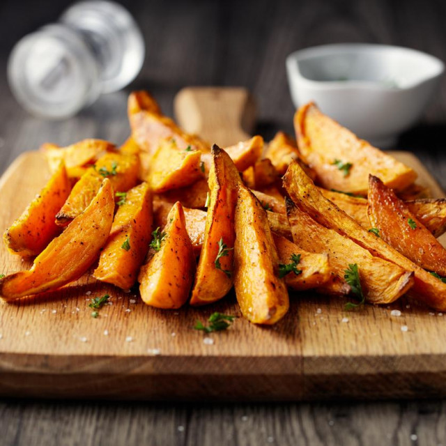 Home made freshness roasted sweet potatoes wedges with garlic herbs