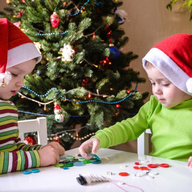 Kids brothers child boys making by hands x-mas decorations. smiling happy boys waiting christmas and Santa