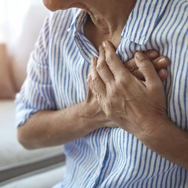 Upset stressed mature middle aged woman feeling pain ache touching chest having heart attack, sad worried senior older lady suffers from heartache at home, infarction or female heart disease concept