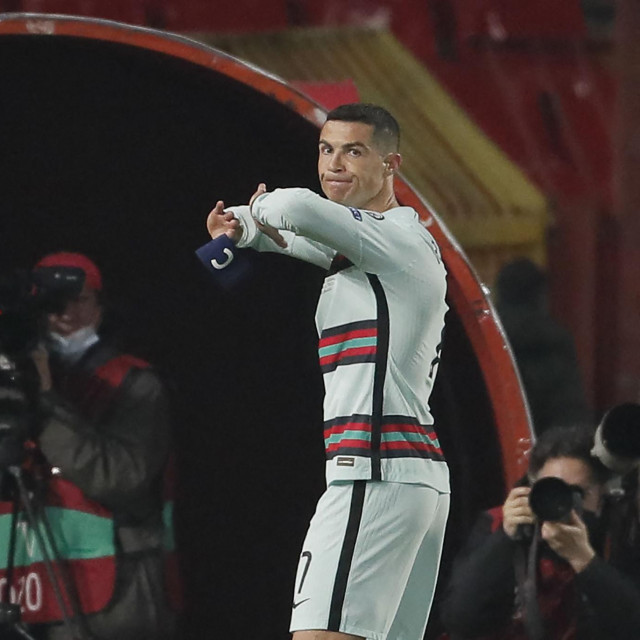 Portugal&amp;#39;s forward Cristiano Ronaldo holds his captain armband moments before he threw it to the ground and left the pitch at the end of the FIFA World Cup Qatar 2022 qualification Group A football match between Serbia and Portugal at the Rajko Mitic Stadium, in Belgrade, on March 27, 2021. - Cristiano Ronaldo threw his captain&amp;#39;s armband to the ground in anger after being controversially denied an injury-time winner as Portugal blew a two-goal lead against Serbia in World Cup qualifying. (Photo by pedja milosavljevic/AFP)