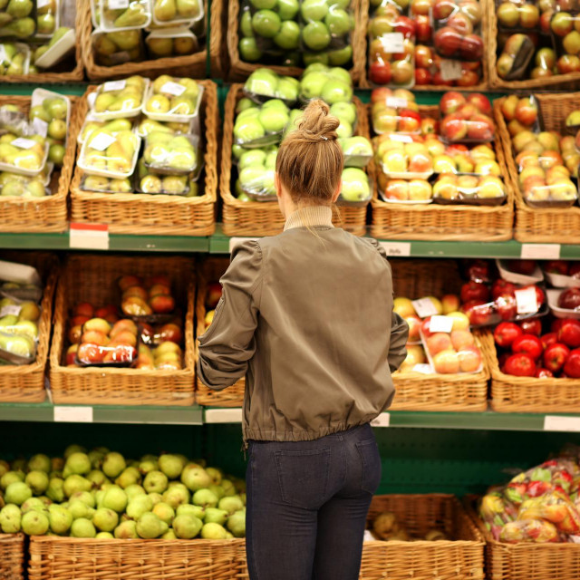 Middle-age woman buying vegetables at the market