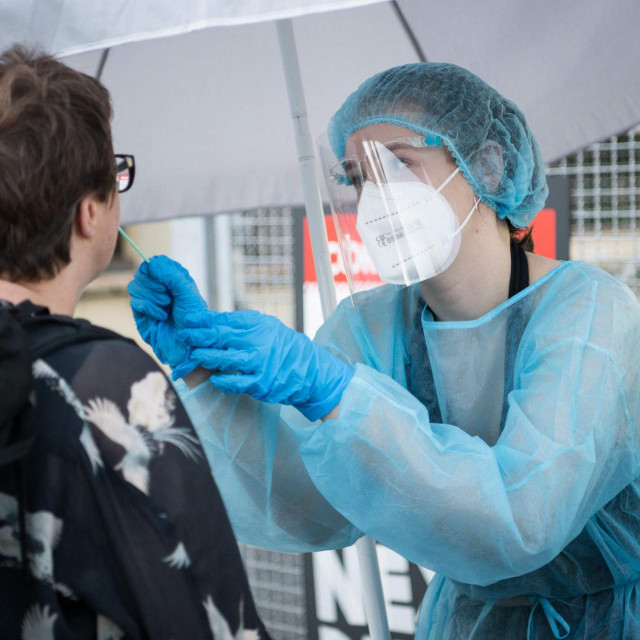 A woman is being tested for the the coronavirus/COVID-19 at a mobile test station in Berlin&amp;#39;s Kreuzberg district on July 30, 2021, amid the ongoing coronavirus/COVID-19 pandemic. (Photo by STEFANIE LOOS/AFP)