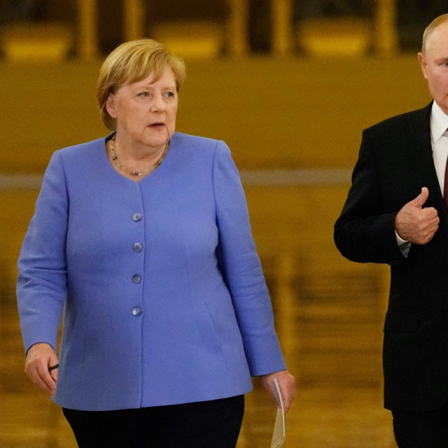 Ruski predsjednik Vladimir Putin i njemačka kancelarka Angela Merkel ulaze u dvoranu na zajedničku konferenciju za novinare