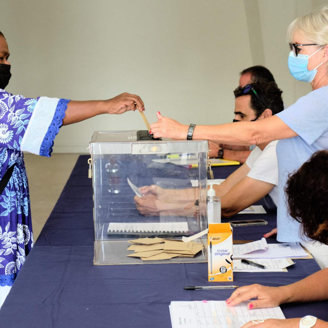 &lt;p&gt;A woman casts her ballot for the referendum on independence at a polling station of the City Hall in Noumea, on the French South Pacific territory of New Caledonia on December 12, 2021. (Photo by Theo Rouby/AFP)&lt;/p&gt;
