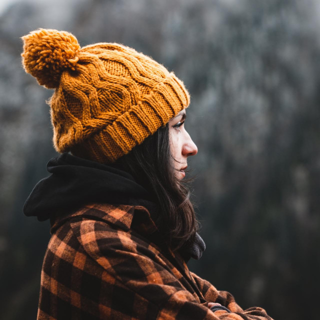 &lt;p&gt;Side view of thoughtful young woman wearing plaid shirt and yellow winter hat looking at view in cold weather conditions. Travel, outdoor and cold weather concept. Copy Space&lt;/p&gt;
