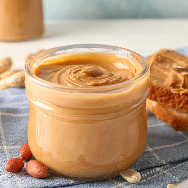 &lt;p&gt;Glass jar with peanut butter, peanut, kitchen towel, spoon and peanut butter sandwich on white wooden background, space for text and closeup&lt;/p&gt;
