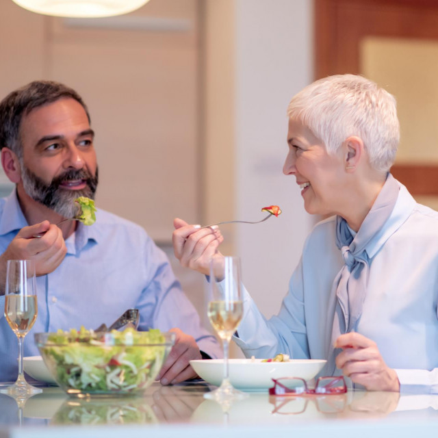 <p>Happy mature couple enjoying food at home.People,love,leisure and food concept.</p>