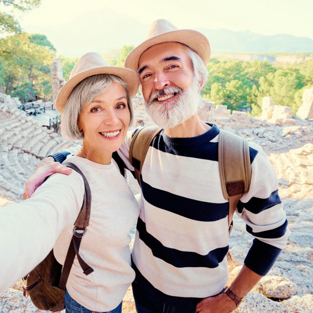 &lt;p&gt;Tourism and technology. Traveling senior couple taking selfie together against ancient sightseeing background.&lt;/p&gt;