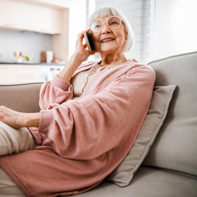 &lt;p&gt;Cheerful senior woman sitting on couch and having phone conversation stock photo&lt;/p&gt;