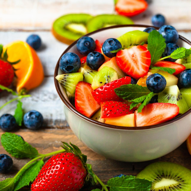 &lt;p&gt;Concept of low calories delicious desserts. Summer fresh bowl with colorful fruit salad. Healthy natural organic food. Tasty sweet snack, light simple tasty lunch. Close up macro view wooden backgroun&lt;/p&gt;